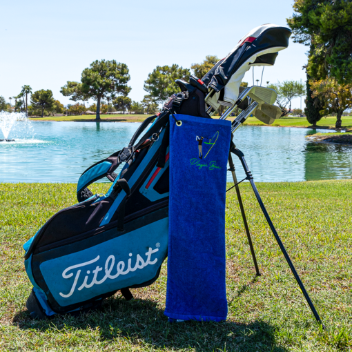 blue golf towel with logo on golf bag