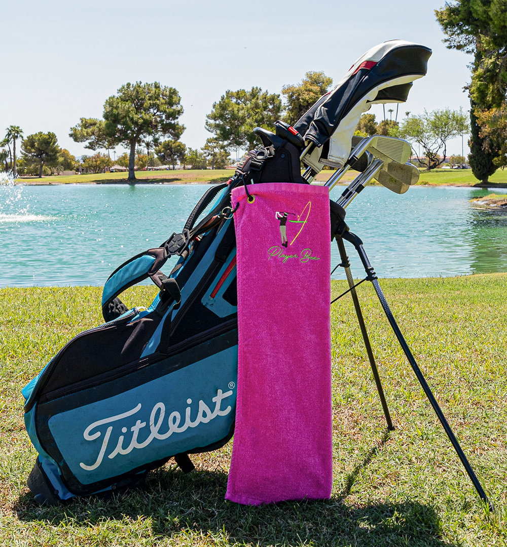 pink golf towel with logo on golf bag