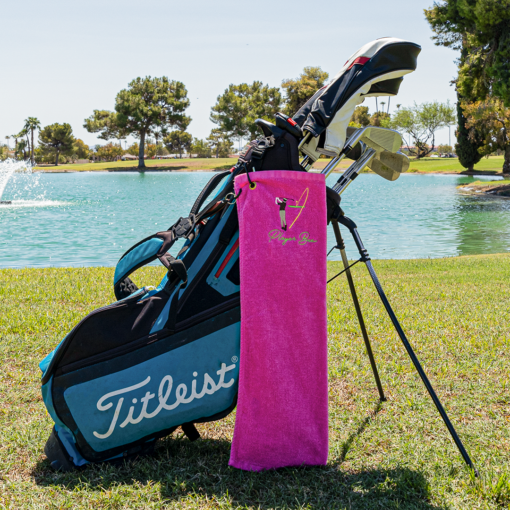 pink golf towel with logo on golf bag