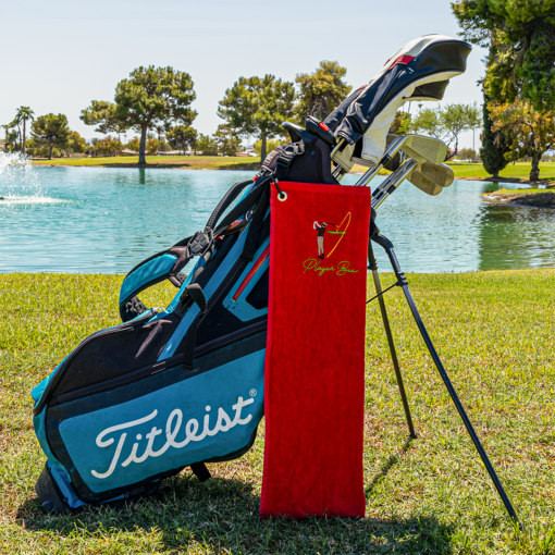 red golf towel with logo on golf bag